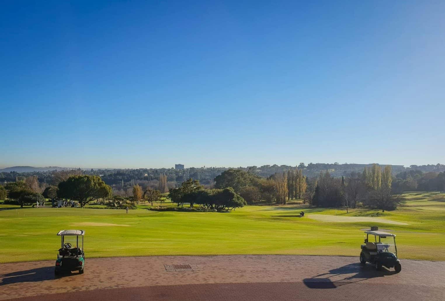 golf cars are parked on the course