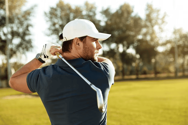 Young man focused on hitting the golf ball
