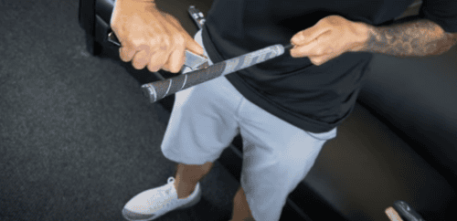 a man regripping a golf club