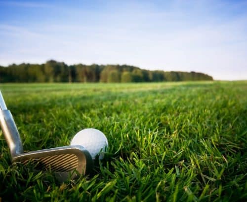 Close up of golf club with a ball