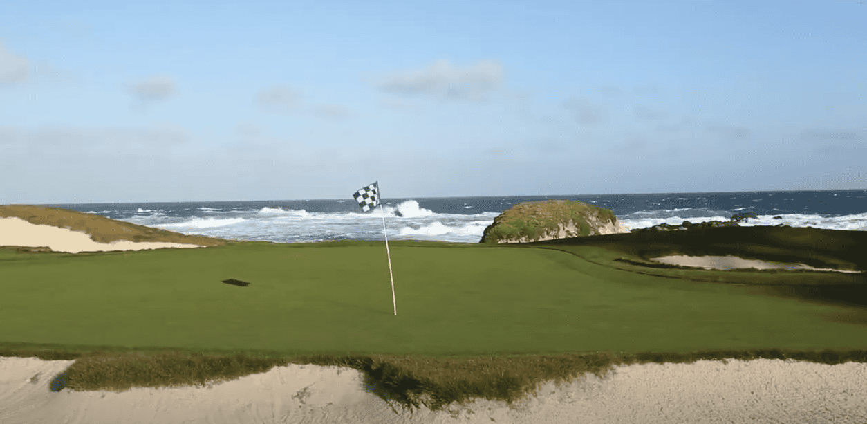 Golf flag positioned by the sea on a golf course