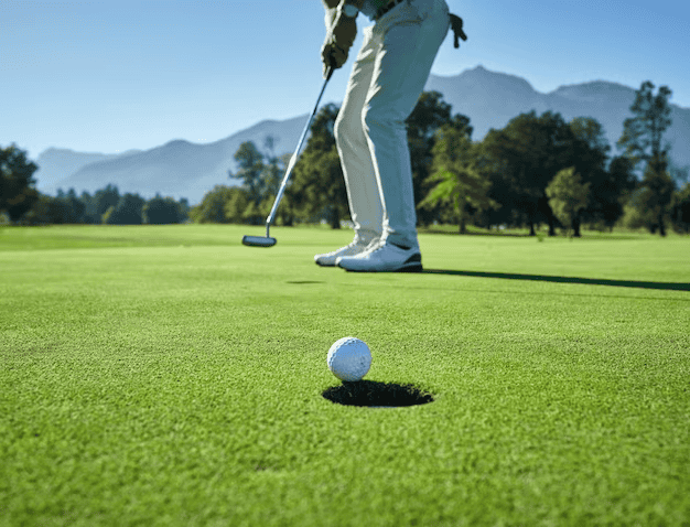 Man Playing Golf with Focus on Ball Near the Hole