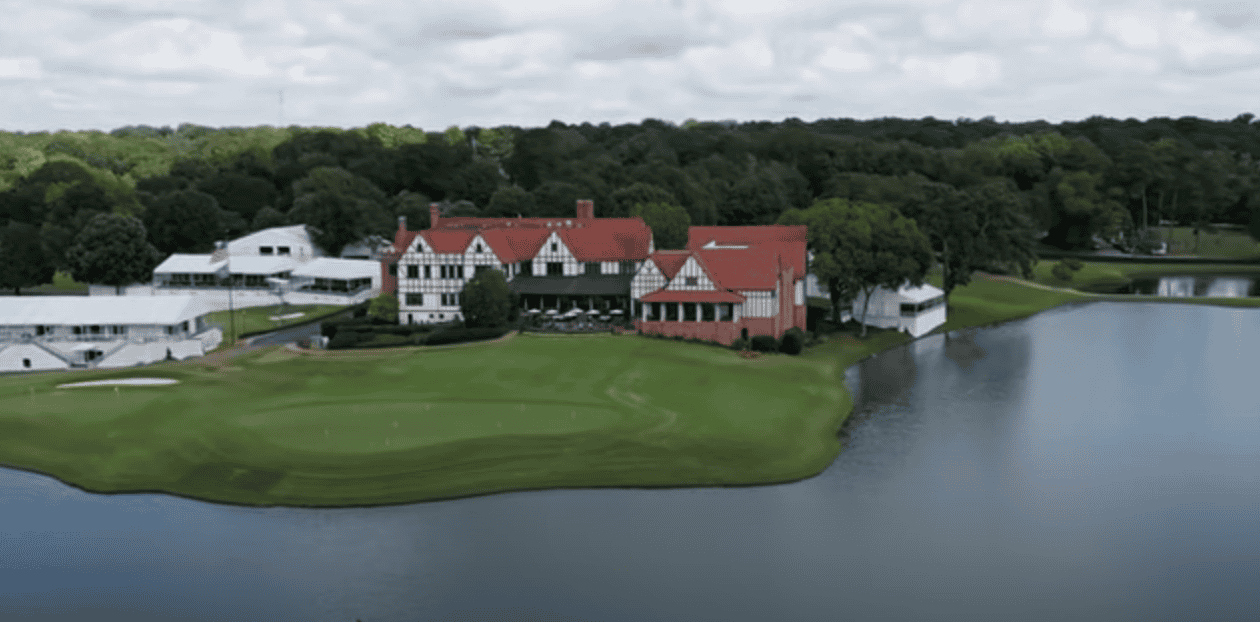 Aerial view of a lakeside golf course with buildings and trees