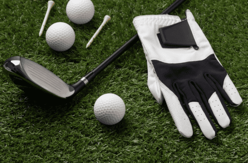 gloves, balls, and golf club on the field