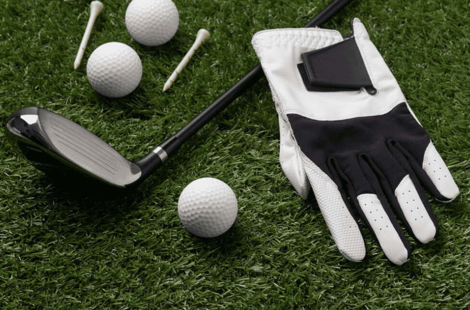 gloves, balls, and golf club on the field